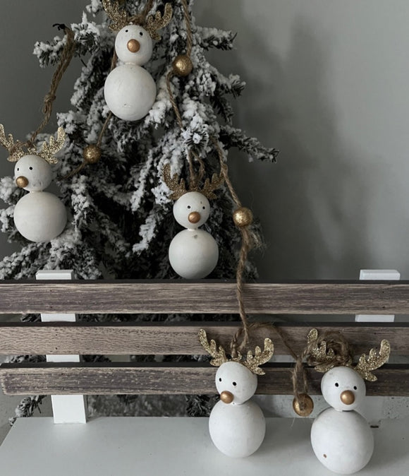 Christmas reindeer garland from Parlane with five white reindeer with gold antlers and a cute gold button nose