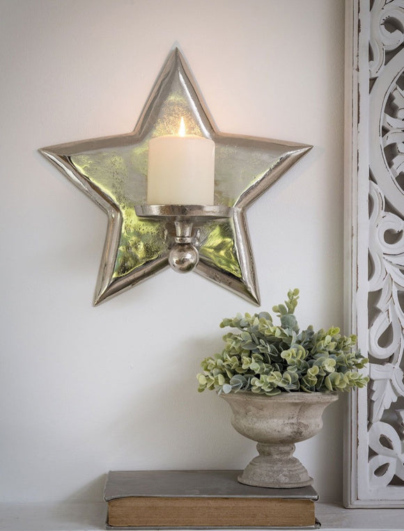 Cast metal star wall sconce finished in silver